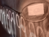 Man with Computer Screen Reflected in Glasses and Binary Code Lámina fotográfica Man with Computer Screen Reflected in Glasses and Binary Code Lámina fotográfica