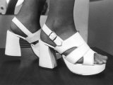 Close-Up Photograph of Feet in a Pair of White Platform Sandals Photographic Print