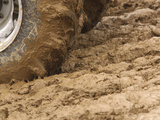 Tire Churning Through Mud Impressão fotográfica