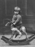 Little Boy on a Very Small Rocking Horse with a Whip in His Hand Photographic Print