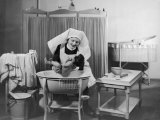 Uniformed Nurse Bathes a Baby in Hospital Photographic Print