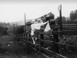 Two Children Stand on a Fence and Wave a Handkerchief at a Passing Steam Train Photographie par Staniland Pugh
