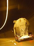 White Tanker Truck Driving Through Tunnel Lit with Electrical Lighting Photographic Print