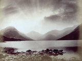 A Lake Surrounded by Mountains in a Stormy Dawn Photographic Print