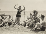 A Young Woman, Surrounded by Musicians, Dances on a Beach of the Lido of Venice Fotografie-Druck