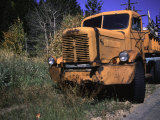 An Orange Truck at a Car Cemetery in Colorado Posters by Michael Brown
