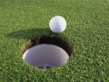 Close-up of a Golf Ball Near a Hole Photographic Print