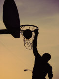 Silhouette of a Man Slam Dunking a Basketball - Fotografik Baskı
