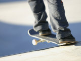 Feet on a Skateboard at the Edge of a Ramp Photographic Print