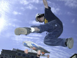 Skateboarder in Midair Doing a Trick Photographic Print