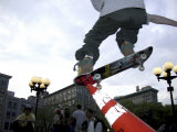 Skateboarder in Midair Knocking Over a Cone Photographic Print