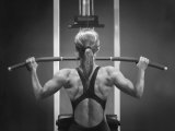 Rear View of a Woman Exercising on a Machine Photographie