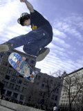 Skateboarder in Midair Doing a Trick Photographic Print
