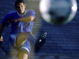 Soccer Player Kicking a Soccer Ball Photographic Print