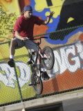 Bicyclist Coming Off a Ramp Photographic Print