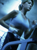 Low Angle View of a Young Woman Running on a Treadmill Photographic Print