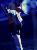 Soccer Player Kicking a Soccer Ball Photographic Print