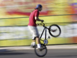 Bicyclist Riding on Rear Wheel Photographic Print