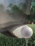Close-up of a Golf Club Hitting a Golf Ball on a Tee Photographic Print