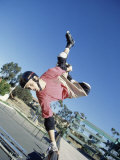 Skateboarder Performing a Handplant on a Ramp Photographic Print