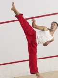 Young Man Kicking While Practicing Karate Photographic Print