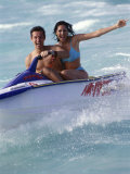 Portrait of a Mid Adult Couple Riding a Jet Ski Photographic Print