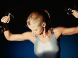 Young Woman Exercising with Dumbbells Photographic Print
