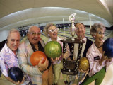 Portrait of a Group of Senior People Holding a Bowling Trophy at a Bowling Alley Photographic Print