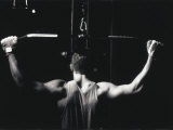 Rear View of a Young Man Exercise on a Lateral Pull-Down Weight Machine Photographic Print