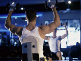 Rear View of a Young Man Exercising with Dumbbells Photographic Print