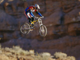 Side Profile of a Person on a Bicycle in Mid Air 写真プリント