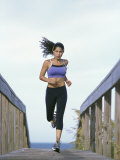 Young Woman Running with Headphones Reprodukcja zdjęcia