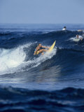 Female Surfer Riding a Wave Photographic Print