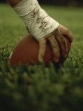 Close-up of the Hand of an American Football Player Holding a Football Fotografisk tryk