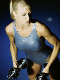 Young Woman Exercising with Dumbbells Photographic Print