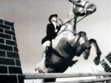 Low Angle View of a Jockey And a Horse Jumping Over a Hurdle Photographic Print