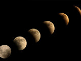 The Full Moon Slowly Loses its Fullness as the Earth's Shadow Crosses It Photographic Print