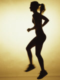 Silhouette of a Young Woman Exercising Lámina fotográfica Silhouette of a Young Woman Exercising Lámina fotográfica