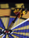 Dart on the Bull's-Eye of a Dart Board Photographic Print