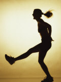 Silhouette of a Young Woman Exercising Lámina fotográfica