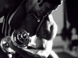 Young Man Exercising with a Dumbbell Photographic Print