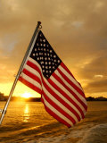 A Flag Waves Over Pearl Harbor as Dawn Breaks Photographic Print