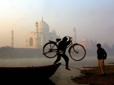 An Unidentified Cyclist Gets Down with His Cycle against the Backdrop of the Taj Mahal Photographic Print