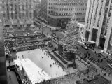 With the Famed Rockefeller Center Christmas Tree Rising Above Them, Skaters Glide on the Ice Photographie