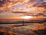 A Young Boy Takes an Early Morning Jog as the Sun Rises Along China Beach Photographie