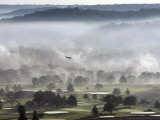 A Small Plane Descends Over Fog Covered Reeves Municipal Golf Course Photographic Print