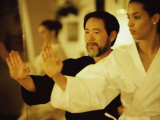Mature Man Teaching a Young Woman Martial Arts Photographic Print