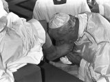 Pope John Paul II Kisses the Feet of One of 12 Mentally Retarded Italians Photographic Print