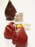 Pair of Boxing Gloves with a Punching Bag and Bandage Tape Lámina fotográfica Pair of Boxing Gloves with a Punching Bag and Bandage Tape Lámina fotográfica