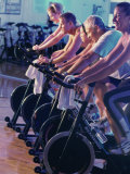 Group of People on Exercise Bikes in a Health Club Photographic Print
